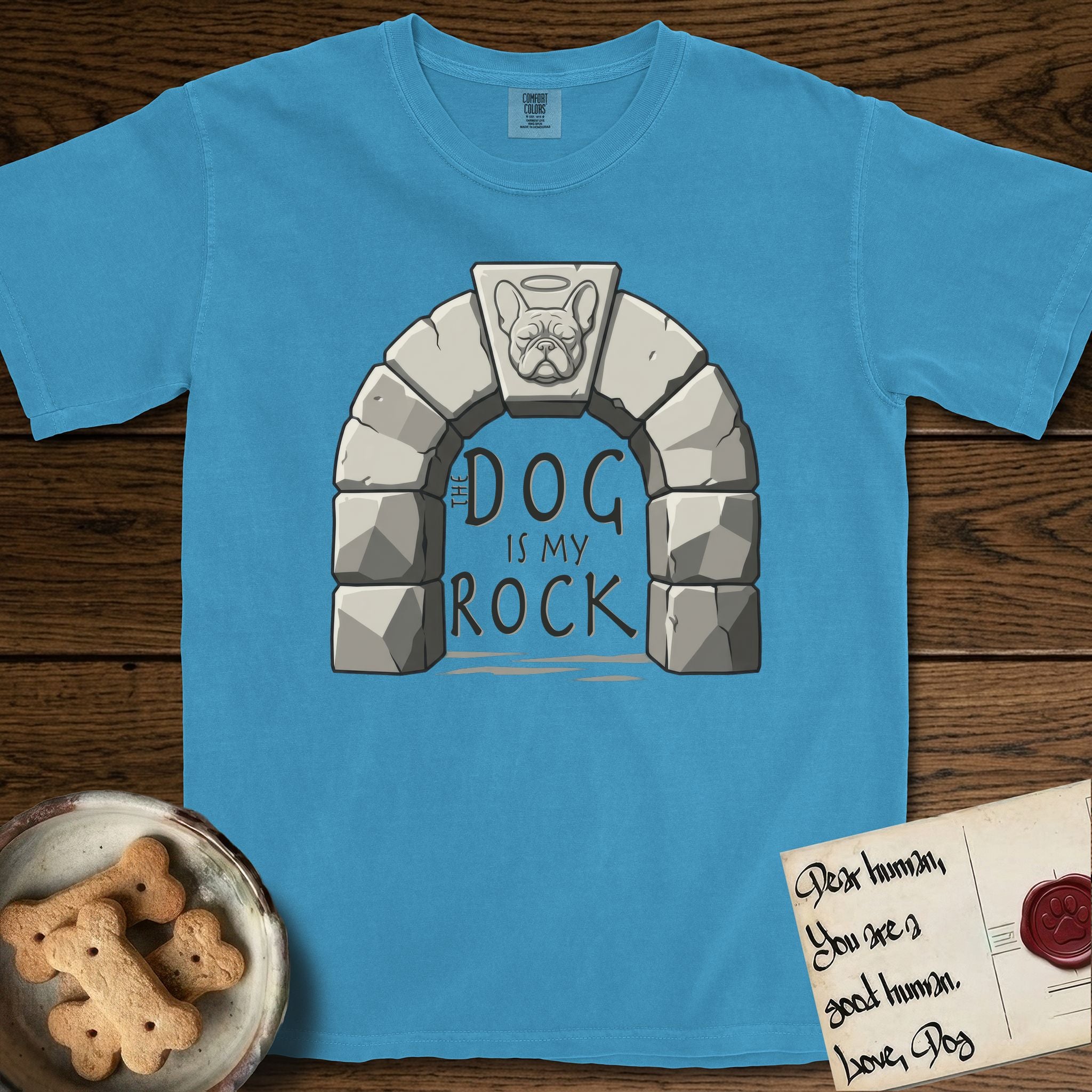 DIMR French Bulldog T-Shirt flat lay in Royal Caribe, featuring carved gray stone arch with a French Bulldog's face in shallow relief on the keystone and a halo above, with the words the Dog is my Rock.