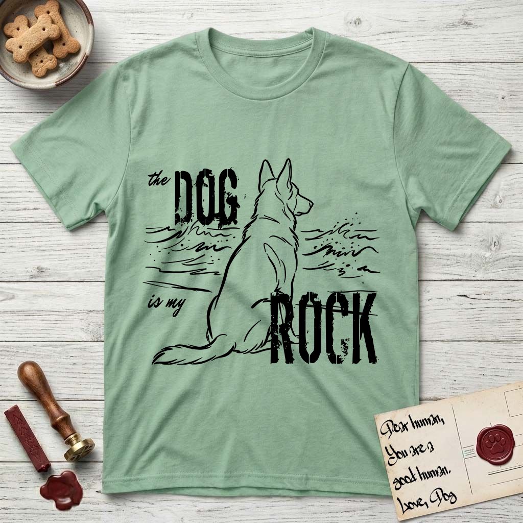 DIMR German Shepherd T-Shirt flat lay in Mint Green, featuring ink-line illustration of a German Shepherd seen from behind, sitting at the waterline and watching a stormy sea, with the words the Dog is my Rock.