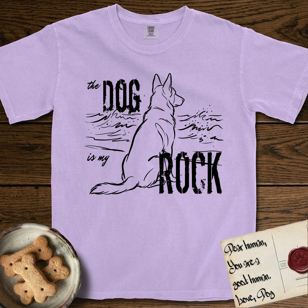 DIMR German Shepherd T-Shirt flat lay in Orchid, featuring ink-line illustration of a German Shepherd seen from behind, sitting at the waterline and watching a stormy sea, with the words the Dog is my Rock.