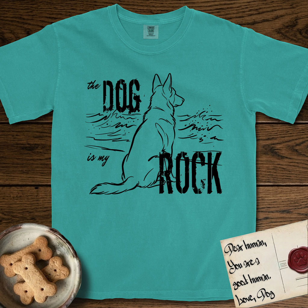 DIMR German Shepherd T-Shirt flat lay in Seafoam, featuring ink-line illustration of a German Shepherd seen from behind, sitting at the waterline and watching a stormy sea, with the words the Dog is my Rock.