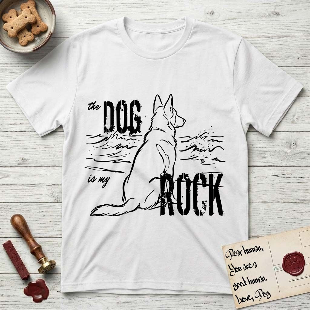 DIMR German Shepherd T-Shirt flat lay in White, featuring ink-line illustration of a German Shepherd seen from behind, sitting at the waterline and watching a stormy sea, with the words the Dog is my Rock.