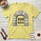 DIMR Lobo T-Shirt flat lay in Cornsilk, featuring carved gray stone arch with Lobo's Cattle Dog face in shallow relief on the keystone and a halo above, with the words the Dog is my Rock.