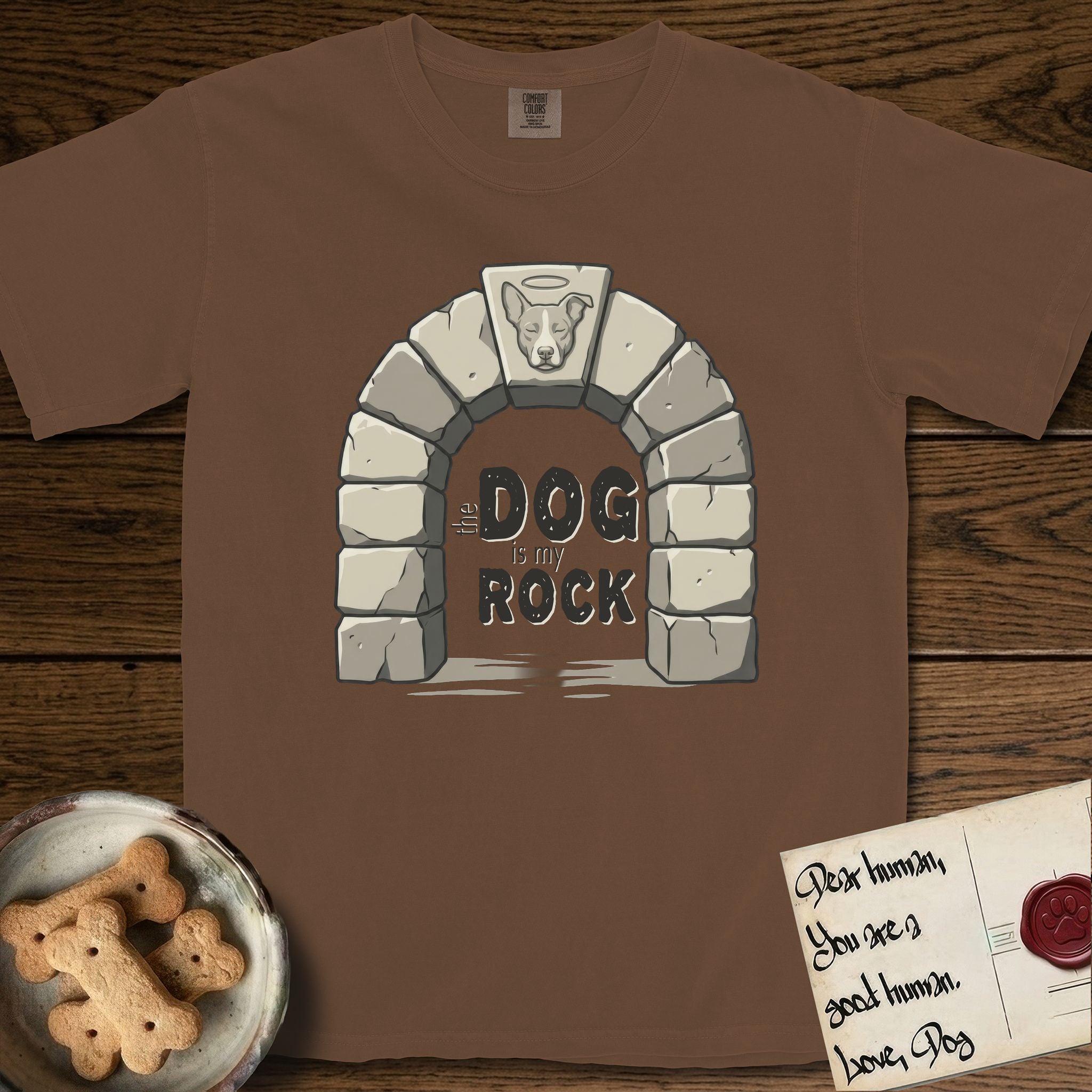 DIMR Lobo T-Shirt flat lay in Espresso, featuring carved gray stone arch with Lobo's Cattle Dog face in shallow relief on the keystone and a halo above, with the words the Dog is my Rock.