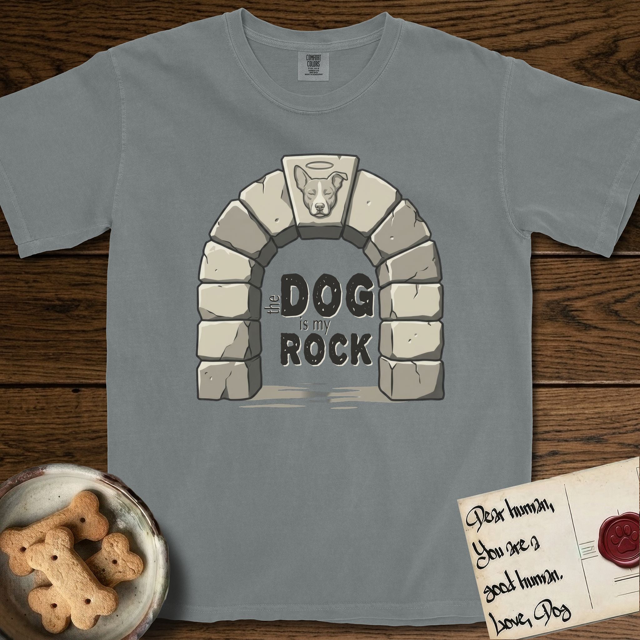 DIMR Lobo T-Shirt flat lay in Granite, featuring carved gray stone arch with Lobo's Cattle Dog face in shallow relief on the keystone and a halo above, with the words the Dog is my Rock.