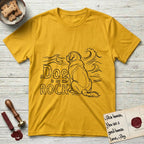 DIMR Saint Bernard T-Shirt flat lay in Daisy, featuring ink-line illustration of a Saint Bernard seen from behind, sitting at the water's edge and watching a stormy sea, with the words the Dog is my Rock.