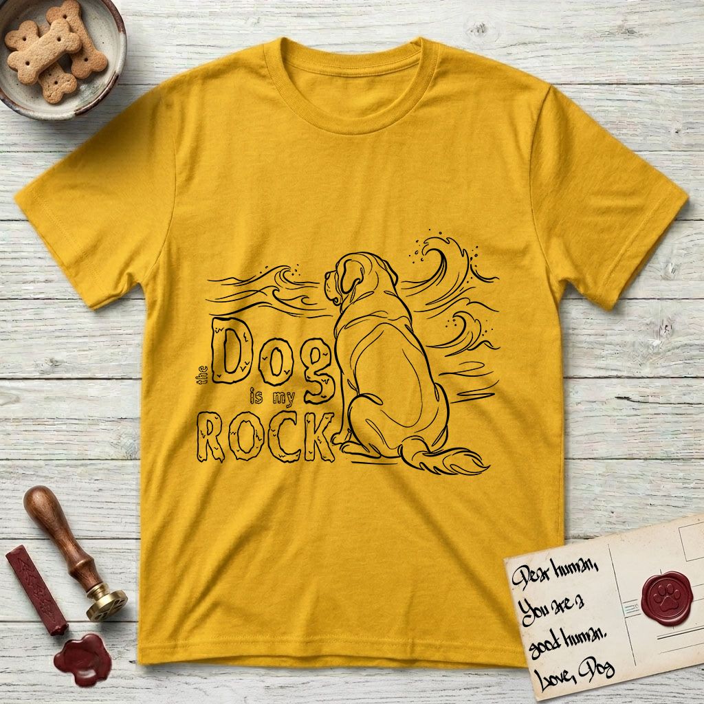 DIMR Saint Bernard T-Shirt flat lay in Daisy, featuring ink-line illustration of a Saint Bernard seen from behind, sitting at the water's edge and watching a stormy sea, with the words the Dog is my Rock.