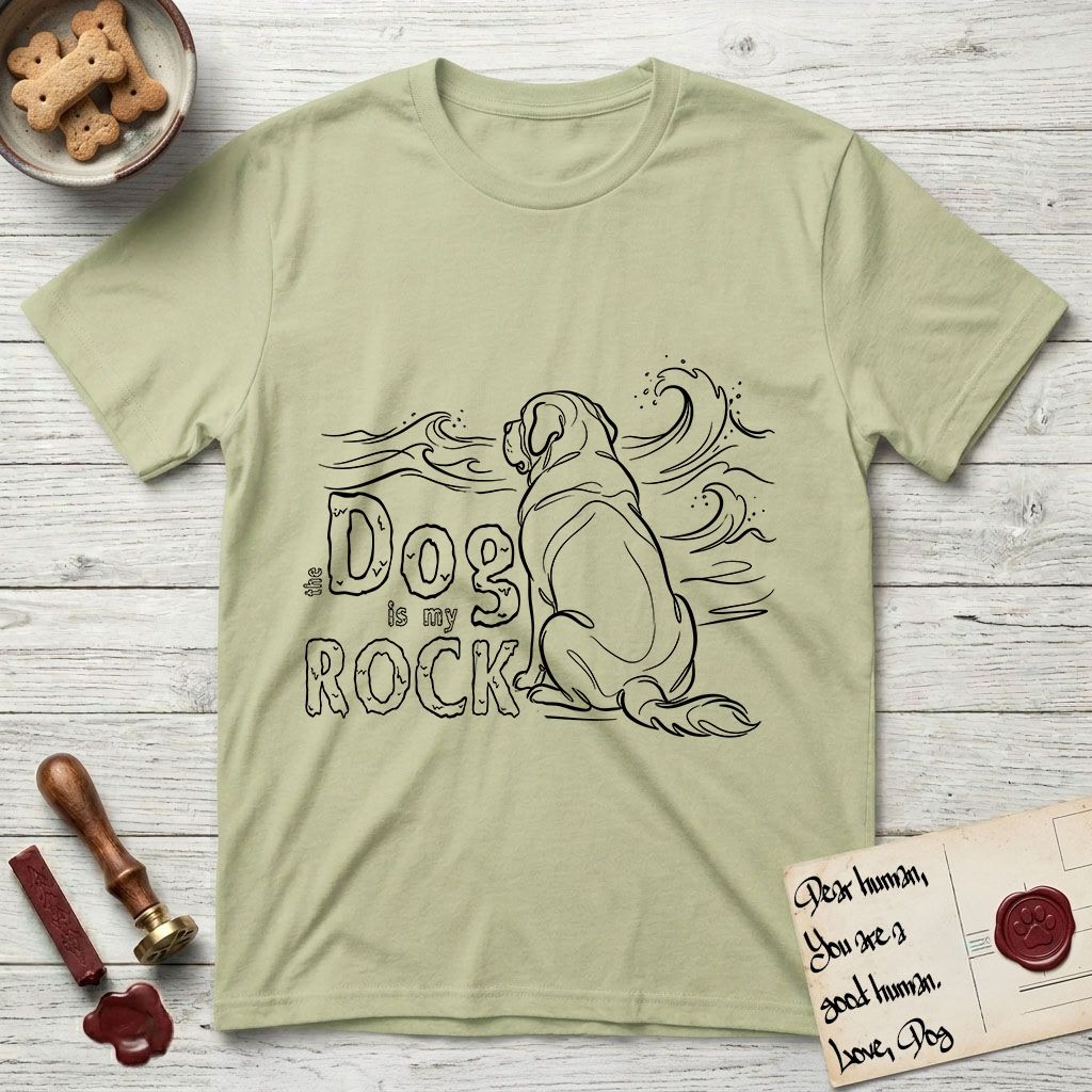DIMR Saint Bernard T-Shirt flat lay in Pistachio, featuring ink-line illustration of a Saint Bernard seen from behind, sitting at the water's edge and watching a stormy sea, with the words the Dog is my Rock.