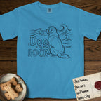 DIMR Saint Bernard T-Shirt flat lay in Royal Caribe, featuring ink-line illustration of a Saint Bernard seen from behind, sitting at the water's edge and watching a stormy sea, with the words the Dog is my Rock.