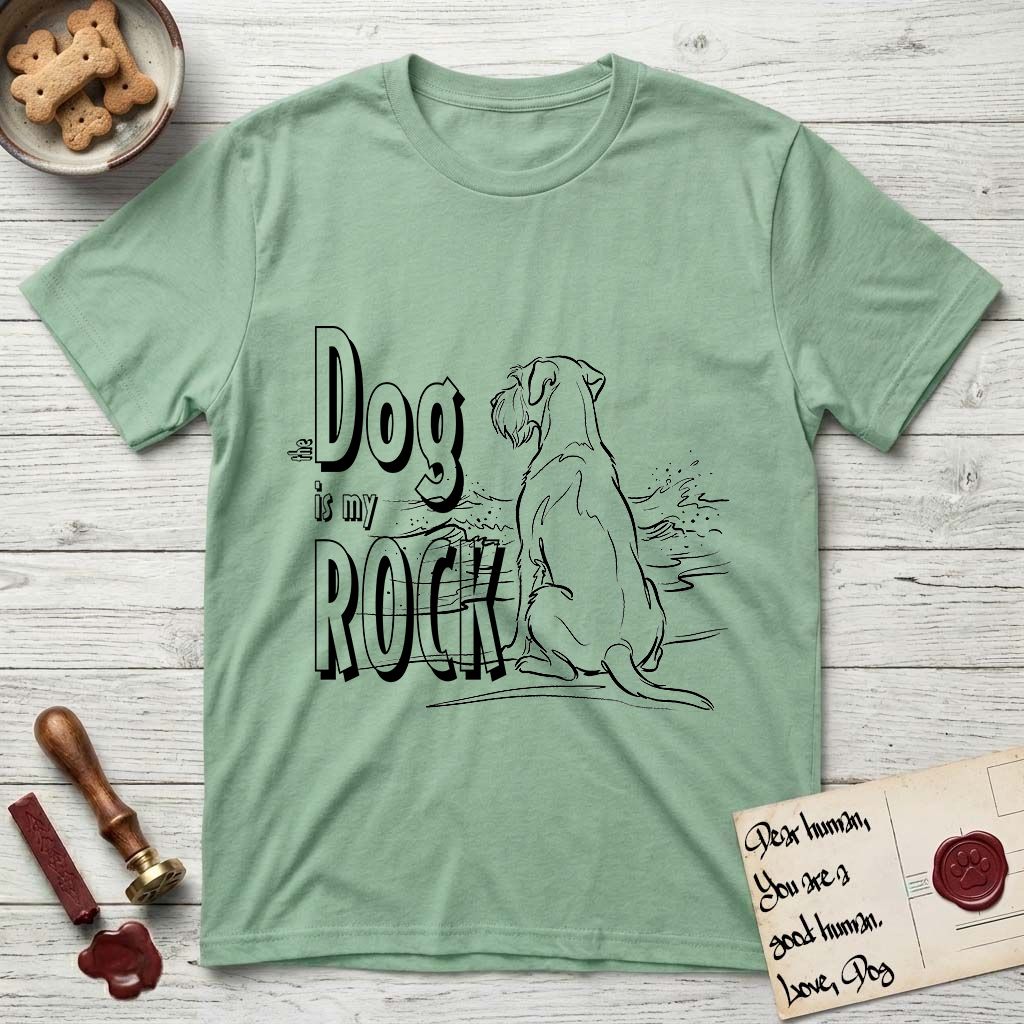 DIMR Schnauzer T-Shirt flat lay in Mint Green, featuring ink-line illustration of a Schnauzer seen from behind at the water's edge, head turned toward a stormy sea, with the words the Dog is my Rock.