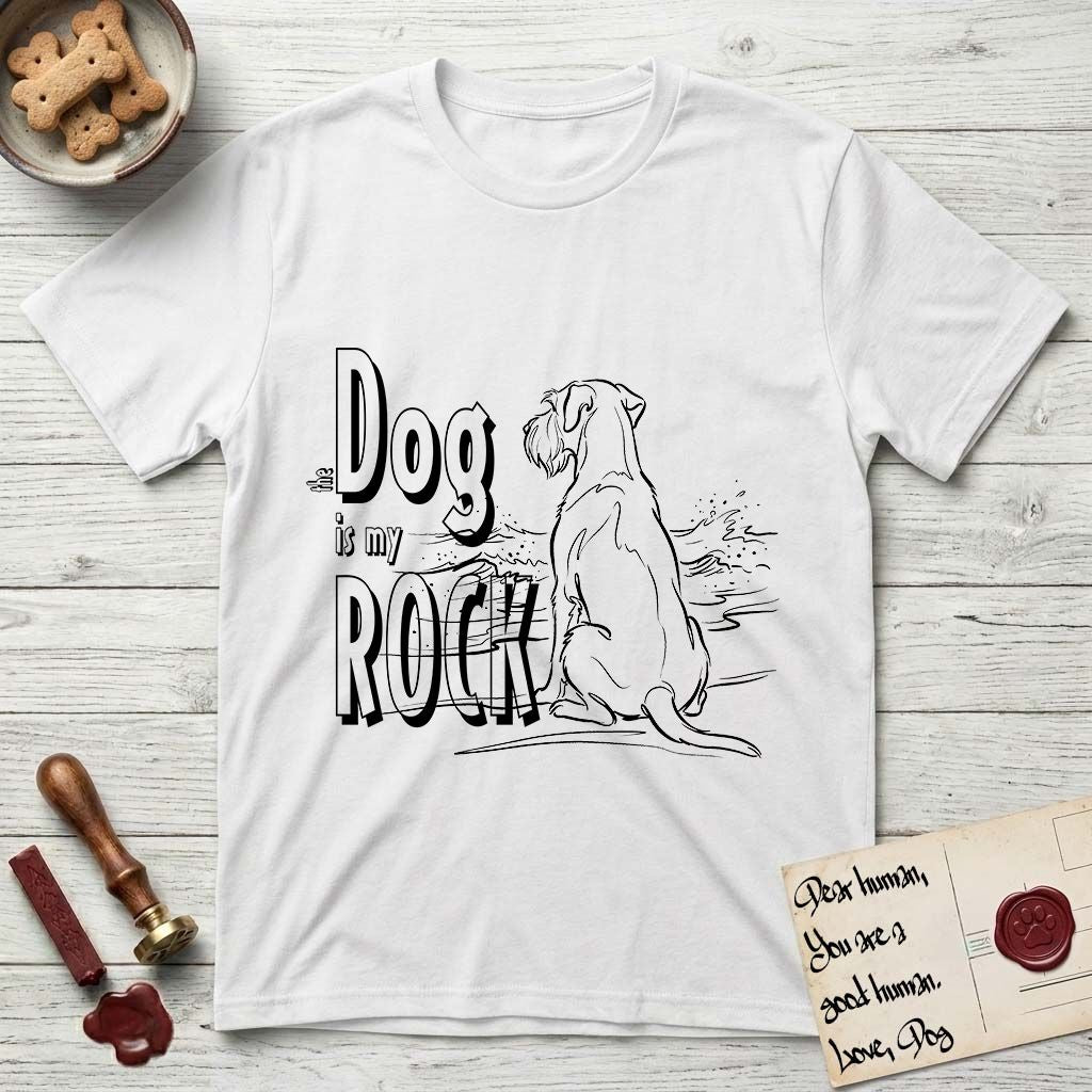 DIMR Schnauzer T-Shirt flat lay in White, featuring ink-line illustration of a Schnauzer seen from behind at the water's edge, head turned toward a stormy sea, with the words the Dog is my Rock.