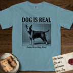 Dog is Real Bull Terrier T-Shirt flat lay in Ice Blue, featuring Black halftone newspaper photo of a Bull Terrier with a white face standing in profile with head turned to the camera, under the headline DOG IS REAL, with the caption Praise Be to Dog. Woof..