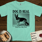 Dog is Real German Shepherd T-Shirt flat lay in Island Reef, featuring Black halftone newspaper photo of a black and tan German Shepherd with upright ears standing in profile with head turned to the camera, under the headline DOG IS REAL, with the caption Praise Be to Dog. Woof..
