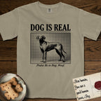 Dog is Real Vizsla T-Shirt flat lay in Khaki, featuring Black halftone newspaper photo of a lean Vizsla with long ears standing in profile with head turned to the camera, under the headline DOG IS REAL, with the caption Praise Be to Dog. Woof..