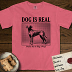 Dog is Real Vizsla T-Shirt flat lay in Watermelon, featuring Black halftone newspaper photo of a lean Vizsla with long ears standing in profile with head turned to the camera, under the headline DOG IS REAL, with the caption Praise Be to Dog. Woof..