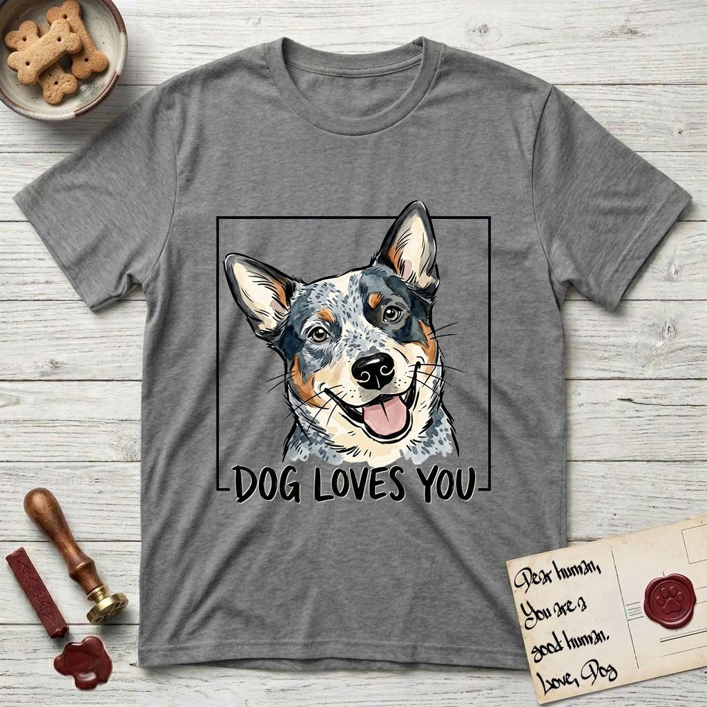 Dog Loves You Australian Cattle Dog T-Shirt flat lay in Graphite Heather, featuring Ink and watercolor portrait of a smiling blue Australian Cattle Dog with a speckled coat, tan eyebrows and upright ears, head tilted inside a black frame above hand-lettered text reading DOG LOVES YOU.