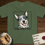 Dog Loves You Australian Cattle Dog T-Shirt flat lay in Moss, featuring Ink and watercolor portrait of a smiling blue Australian Cattle Dog with a speckled coat, tan eyebrows and upright ears, head tilted inside a black frame above hand-lettered text reading DOG LOVES YOU.