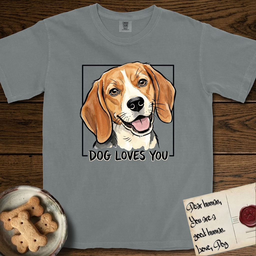 Dog Loves You Beagle T-Shirt flat lay in Granite, featuring Ink and watercolor portrait of a smiling tricolor Beagle with long hanging ears and a cream blaze, head tilted inside a black frame above hand-lettered text reading DOG LOVES YOU.