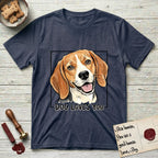 Dog Loves You Beagle T-Shirt flat lay in Heather Navy, featuring Ink and watercolor portrait of a smiling tricolor Beagle with long hanging ears and a cream blaze, head tilted inside a black frame above hand-lettered text reading DOG LOVES YOU.