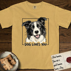 Dog Loves You Border Collie T-Shirt flat lay in Mustard, featuring Ink and watercolor portrait of a smiling black and white Border Collie with a cream blaze and semi-erect ears, head tilted inside a black frame above hand-lettered text reading DOG LOVES YOU.