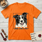Dog Loves You Border Collie T-Shirt flat lay in Orange, featuring Ink and watercolor portrait of a smiling black and white Border Collie with a cream blaze and semi-erect ears, head tilted inside a black frame above hand-lettered text reading DOG LOVES YOU.