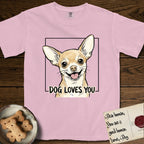 Dog Loves You Chihuahua T-Shirt flat lay in Blossom, featuring Ink and watercolor portrait of a smiling fawn Chihuahua with enormous upright bat ears and big round dark eyes, head tilted inside a black frame above hand-lettered text reading DOG LOVES YOU.