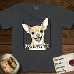 Dog Loves You Chihuahua T-Shirt flat lay in Graphite, featuring Ink and watercolor portrait of a smiling fawn Chihuahua with enormous upright bat ears and big round dark eyes, head tilted inside a black frame above hand-lettered text reading DOG LOVES YOU.