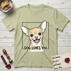 Dog Loves You Chihuahua T-Shirt flat lay in Pistachio, featuring Ink and watercolor portrait of a smiling fawn Chihuahua with enormous upright bat ears and big round dark eyes, head tilted inside a black frame above hand-lettered text reading DOG LOVES YOU.