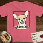 Dog Loves You Chihuahua T-Shirt flat lay in Watermelon, featuring Ink and watercolor portrait of a smiling fawn Chihuahua with enormous upright bat ears and big round dark eyes, head tilted inside a black frame above hand-lettered text reading DOG LOVES YOU.