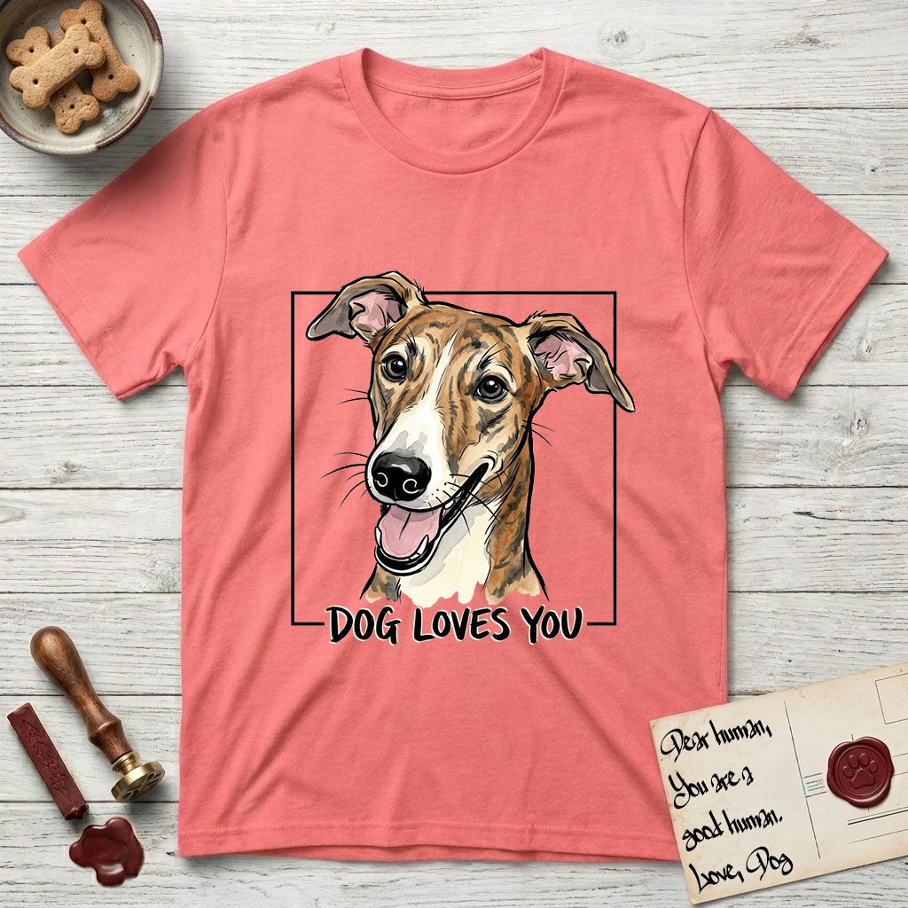 Dog Loves You Galgo T-Shirt flat lay in Coral Silk, featuring Ink and watercolor portrait of a smiling brindle Galgo with a long narrow muzzle and folded rose ears, head tilted inside a black frame above hand-lettered text reading DOG LOVES YOU.