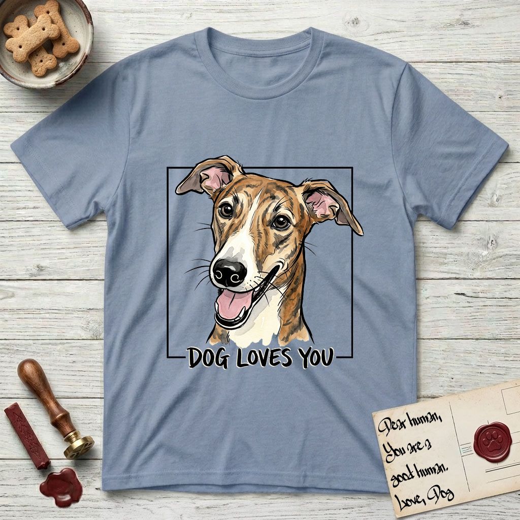 Dog Loves You Galgo T-Shirt flat lay in Stone Blue, featuring Ink and watercolor portrait of a smiling brindle Galgo with a long narrow muzzle and folded rose ears, head tilted inside a black frame above hand-lettered text reading DOG LOVES YOU.