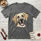 Dog Loves You Great Dane T-Shirt flat lay in Dark Heather, featuring Ink and watercolor portrait of a smiling fawn Great Dane with a black mask and natural floppy ears, head tilted inside a black frame above hand-lettered text reading DOG LOVES YOU.