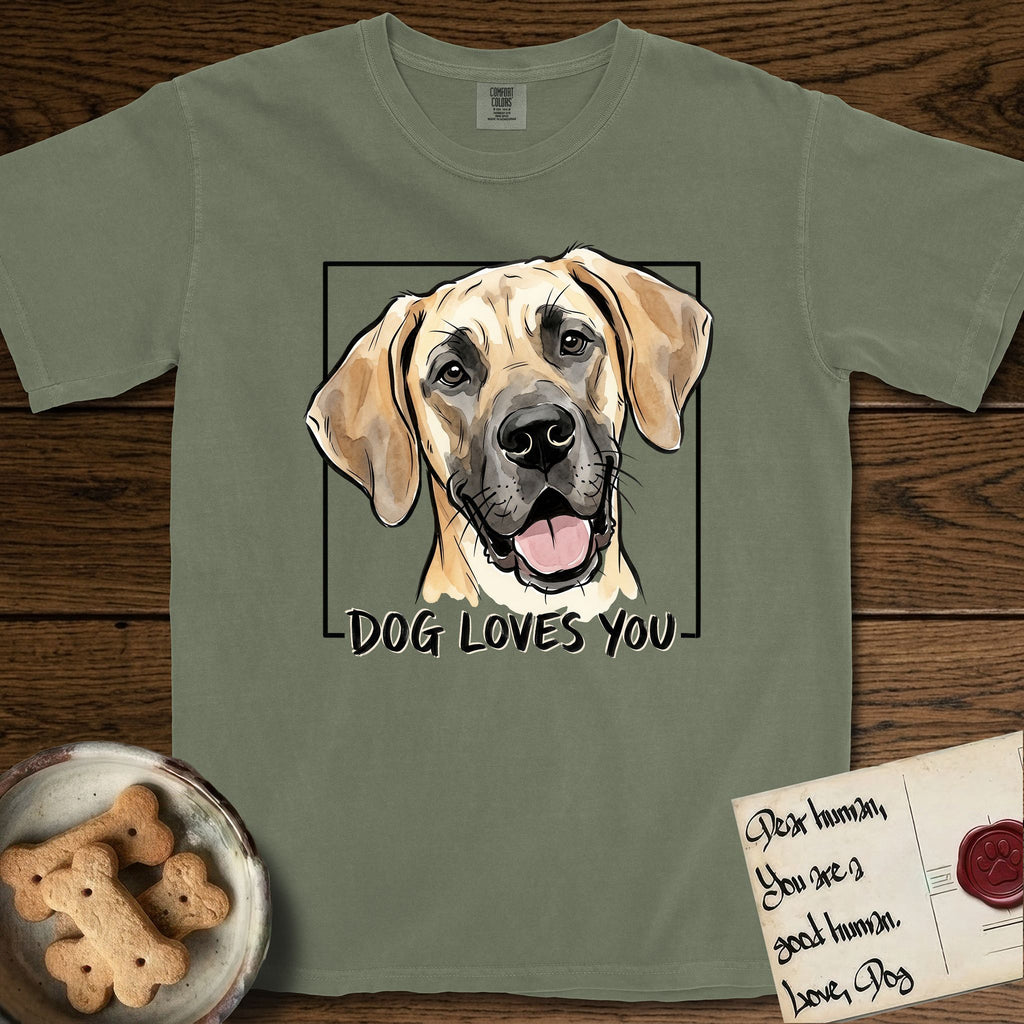 Dog Loves You Great Dane T-Shirt flat lay in Sage, featuring Ink and watercolor portrait of a smiling fawn Great Dane with a black mask and natural floppy ears, head tilted inside a black frame above hand-lettered text reading DOG LOVES YOU.