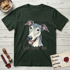 Dog Loves You Greyhound T-Shirt flat lay in Forest Green, featuring Ink and watercolor portrait of a smiling slate blue Greyhound with a long narrow muzzle, cream blaze and folded rose ears, head tilted inside a black frame above hand-lettered text reading DOG LOVES YOU.