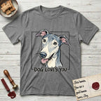Dog Loves You Greyhound T-Shirt flat lay in Graphite Heather, featuring Ink and watercolor portrait of a smiling slate blue Greyhound with a long narrow muzzle, cream blaze and folded rose ears, head tilted inside a black frame above hand-lettered text reading DOG LOVES YOU.