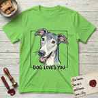 Dog Loves You Greyhound T-Shirt flat lay in Lime, featuring Ink and watercolor portrait of a smiling slate blue Greyhound with a long narrow muzzle, cream blaze and folded rose ears, head tilted inside a black frame above hand-lettered text reading DOG LOVES YOU.