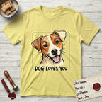 Dog Loves You Jack Russell T-Shirt flat lay in Cornsilk, featuring Ink and watercolor portrait of a smiling cream and rust Jack Russell with folded button ears and keen dark eyes, head tilted inside a black frame above hand-lettered text reading DOG LOVES YOU.