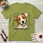 Dog Loves You Jack Russell T-Shirt flat lay in Kiwi, featuring Ink and watercolor portrait of a smiling cream and rust Jack Russell with folded button ears and keen dark eyes, head tilted inside a black frame above hand-lettered text reading DOG LOVES YOU.