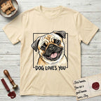 Dog Loves You Pug T-Shirt flat lay in Natural, featuring Ink and watercolor portrait of a smiling fawn Pug with a black mask, deep brow wrinkles and big round eyes, head tilted inside a black frame above hand-lettered text reading DOG LOVES YOU.