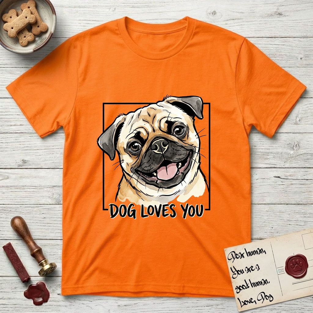 Dog Loves You Pug T-Shirt flat lay in Orange, featuring Ink and watercolor portrait of a smiling fawn Pug with a black mask, deep brow wrinkles and big round eyes, head tilted inside a black frame above hand-lettered text reading DOG LOVES YOU.