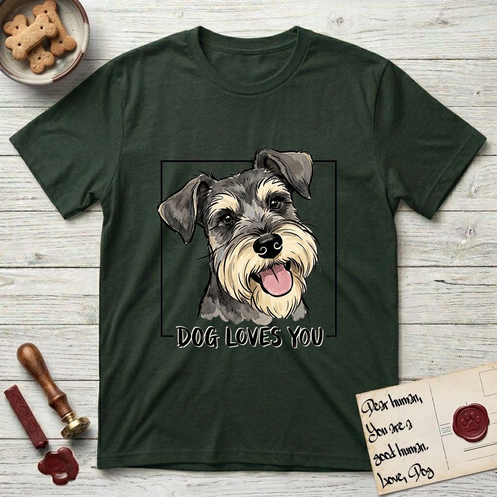 Dog Loves You Schnauzer T-Shirt flat lay in Forest Green, featuring Ink and watercolor portrait of a smiling salt and pepper Schnauzer with a long beard and bushy eyebrows, head tilted inside a black frame above hand-lettered text reading DOG LOVES YOU.