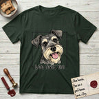 Dog Loves You Schnauzer T-Shirt flat lay in Forest Green, featuring Ink and watercolor portrait of a smiling salt and pepper Schnauzer with a long beard and bushy eyebrows, head tilted inside a black frame above hand-lettered text reading DOG LOVES YOU.