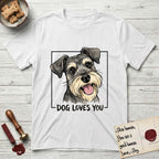 Dog Loves You Schnauzer T-Shirt flat lay in White, featuring Ink and watercolor portrait of a smiling salt and pepper Schnauzer with a long beard and bushy eyebrows, head tilted inside a black frame above hand-lettered text reading DOG LOVES YOU.