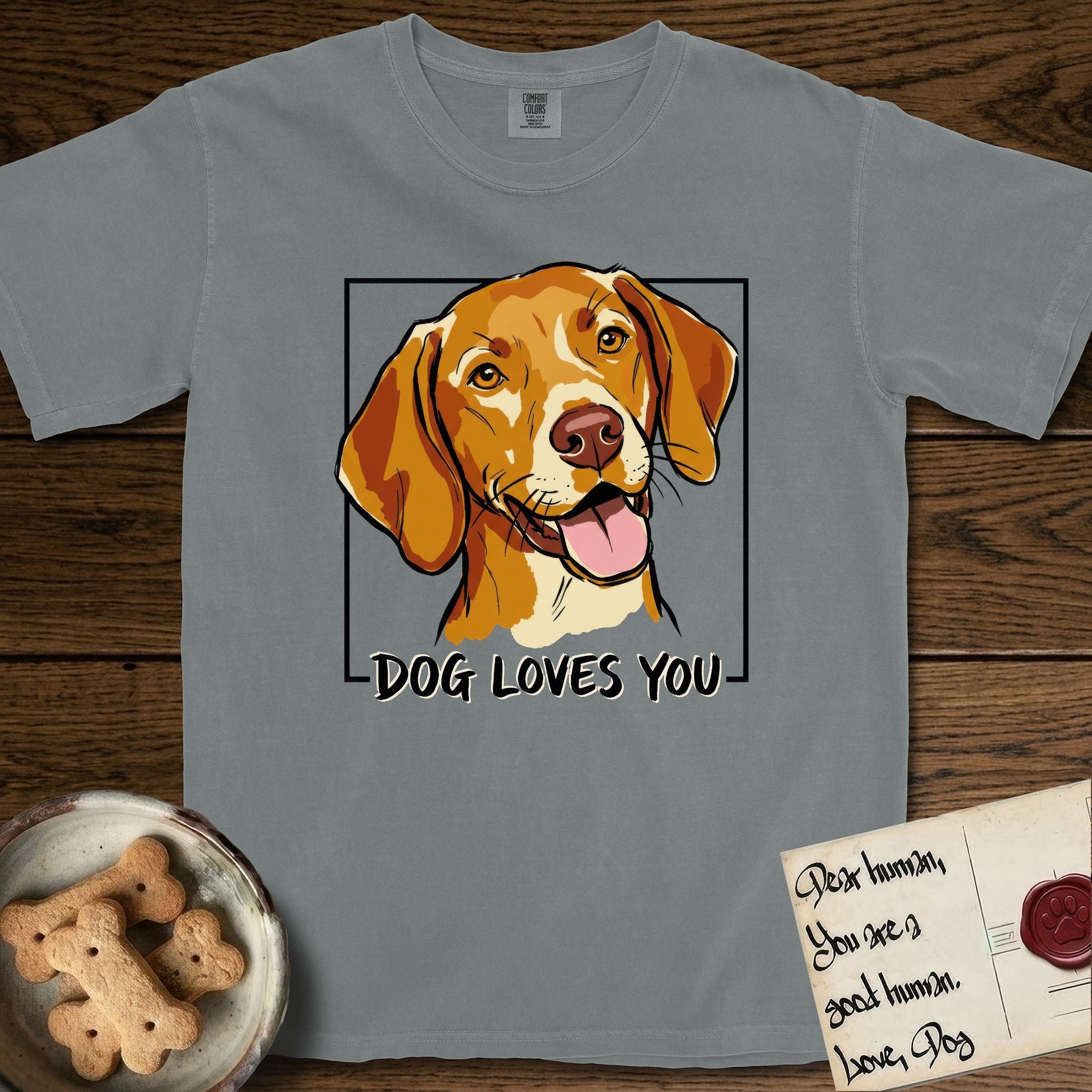 Dog Loves You Vizsla T-Shirt flat lay in Granite, featuring Ink and watercolor portrait of a smiling golden rust Vizsla with long silky hanging ears and amber eyes, head tilted inside a black frame above hand-lettered text reading DOG LOVES YOU.