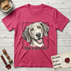 Dog Loves You Weimaraner T-Shirt flat lay in Heather Red, featuring Ink and watercolor portrait of a smiling silver grey Weimaraner with long velvet hanging ears and pale amber eyes, head tilted inside a black frame above hand-lettered text reading DOG LOVES YOU.