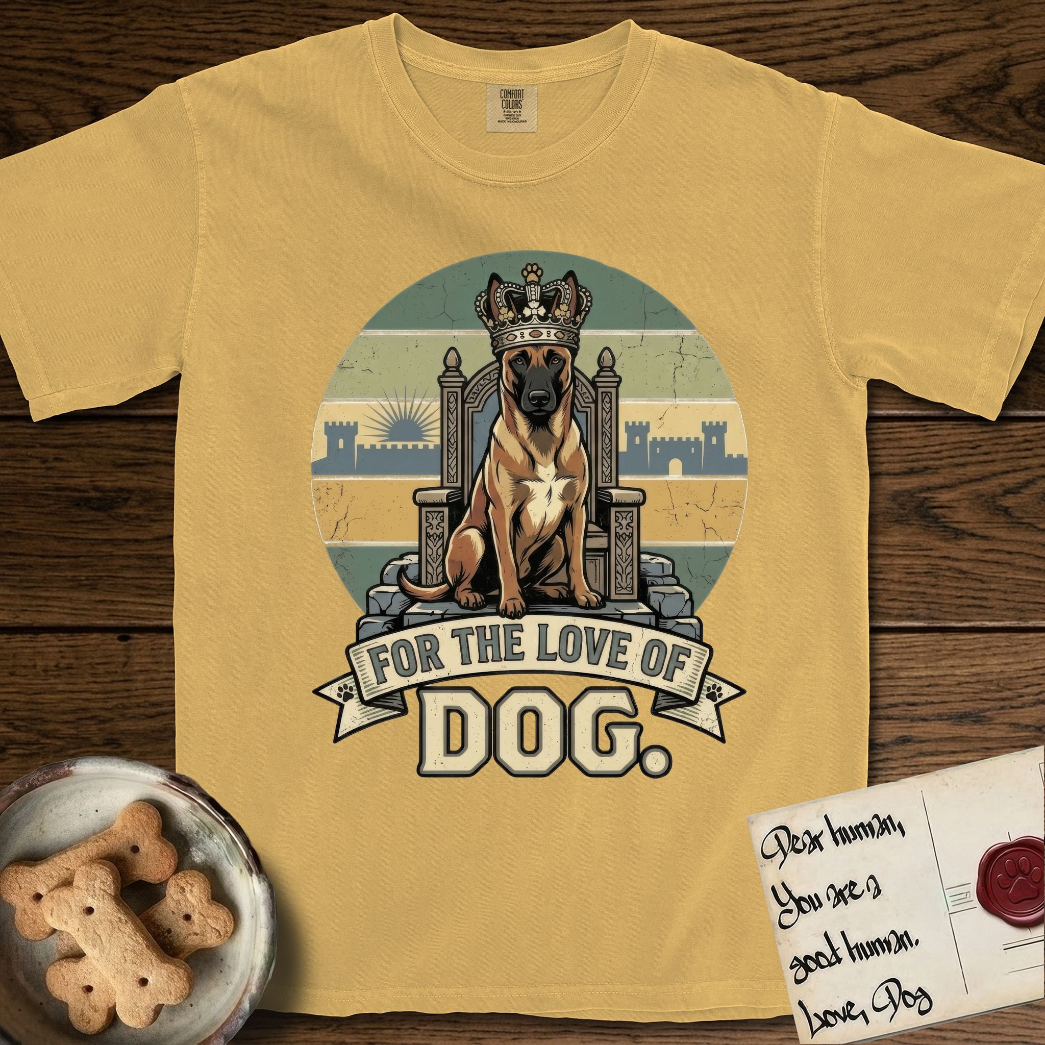 For the Love of Dog Belgian Malinois T-Shirt flat lay in Mustard, featuring a vintage badge of a crowned Belgian Malinois seated on a throne.