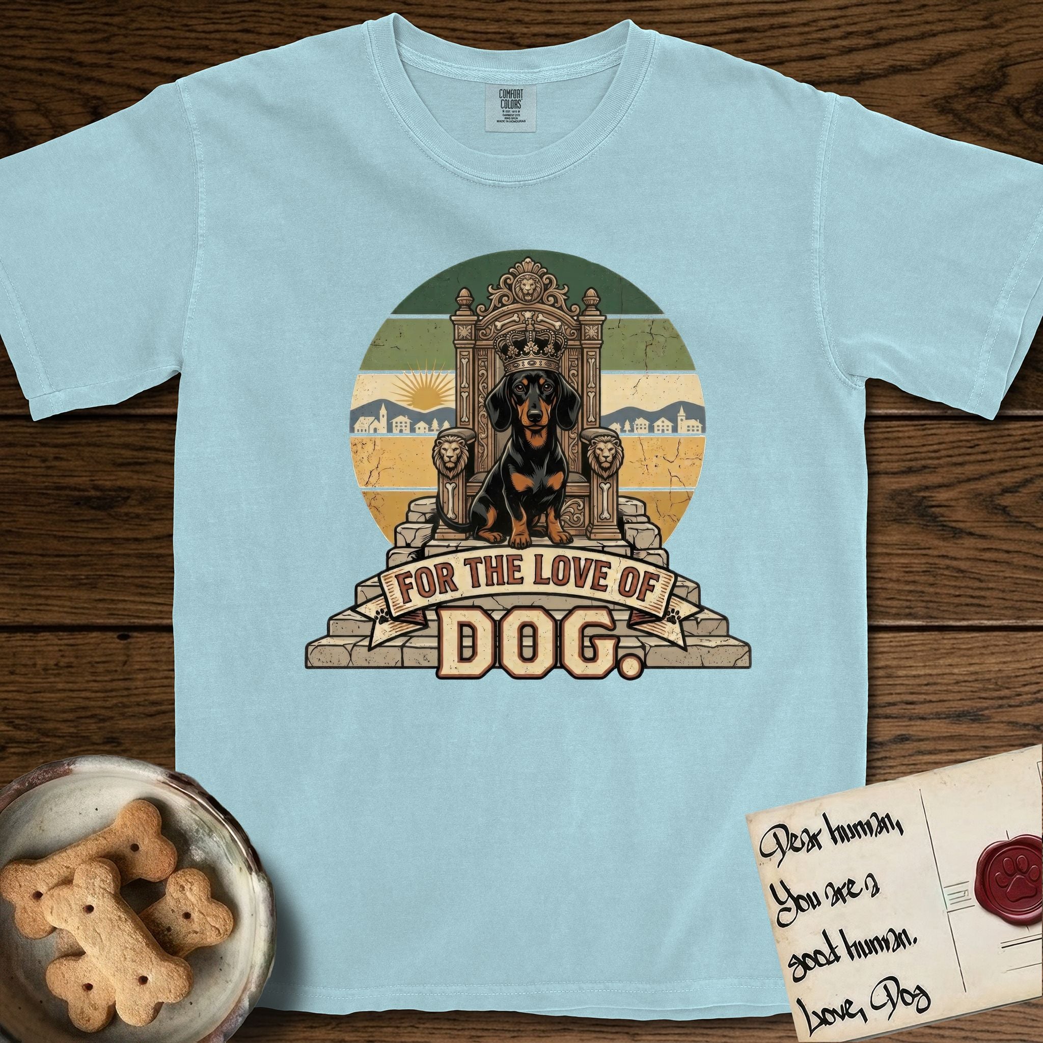 For the Love of Dog Dachshund T-Shirt flat lay in Chambray, featuring a vintage badge of a crowned Dachshund seated on a throne.