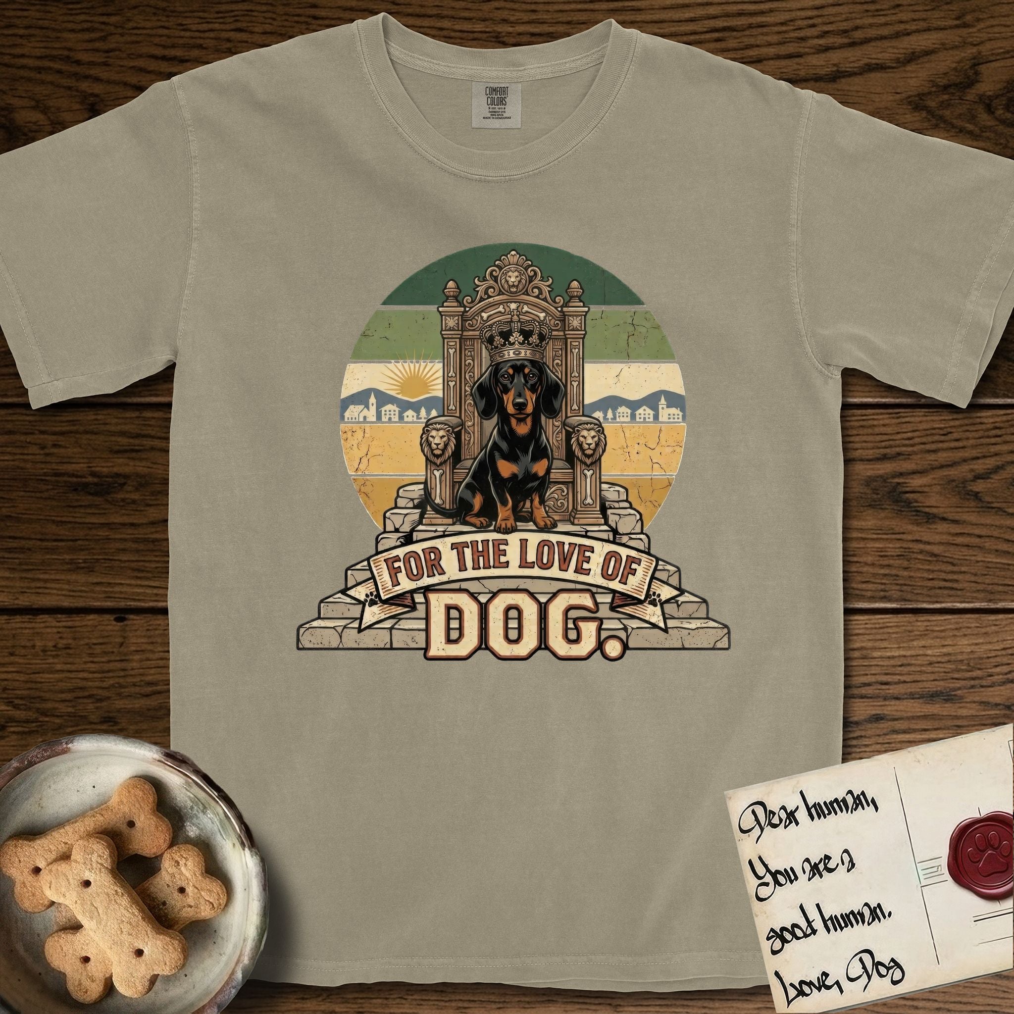 For the Love of Dog Dachshund T-Shirt flat lay in Khaki, featuring a vintage badge of a crowned Dachshund seated on a throne.
