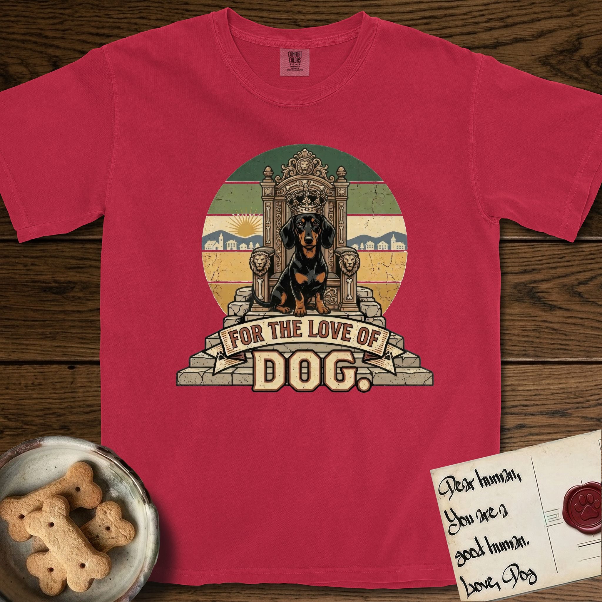 For the Love of Dog Dachshund T-Shirt flat lay in Red, featuring a vintage badge of a crowned Dachshund seated on a throne.