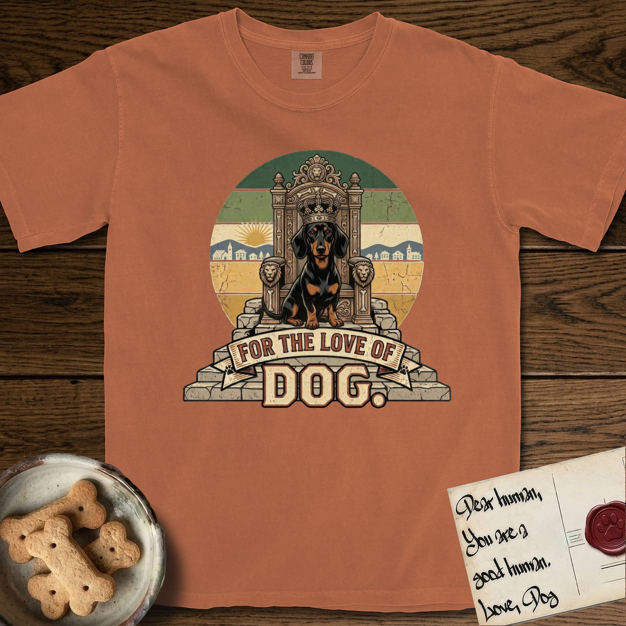 For the Love of Dog Dachshund T-Shirt flat lay in Yam, featuring a vintage badge of a crowned Dachshund seated on a throne.