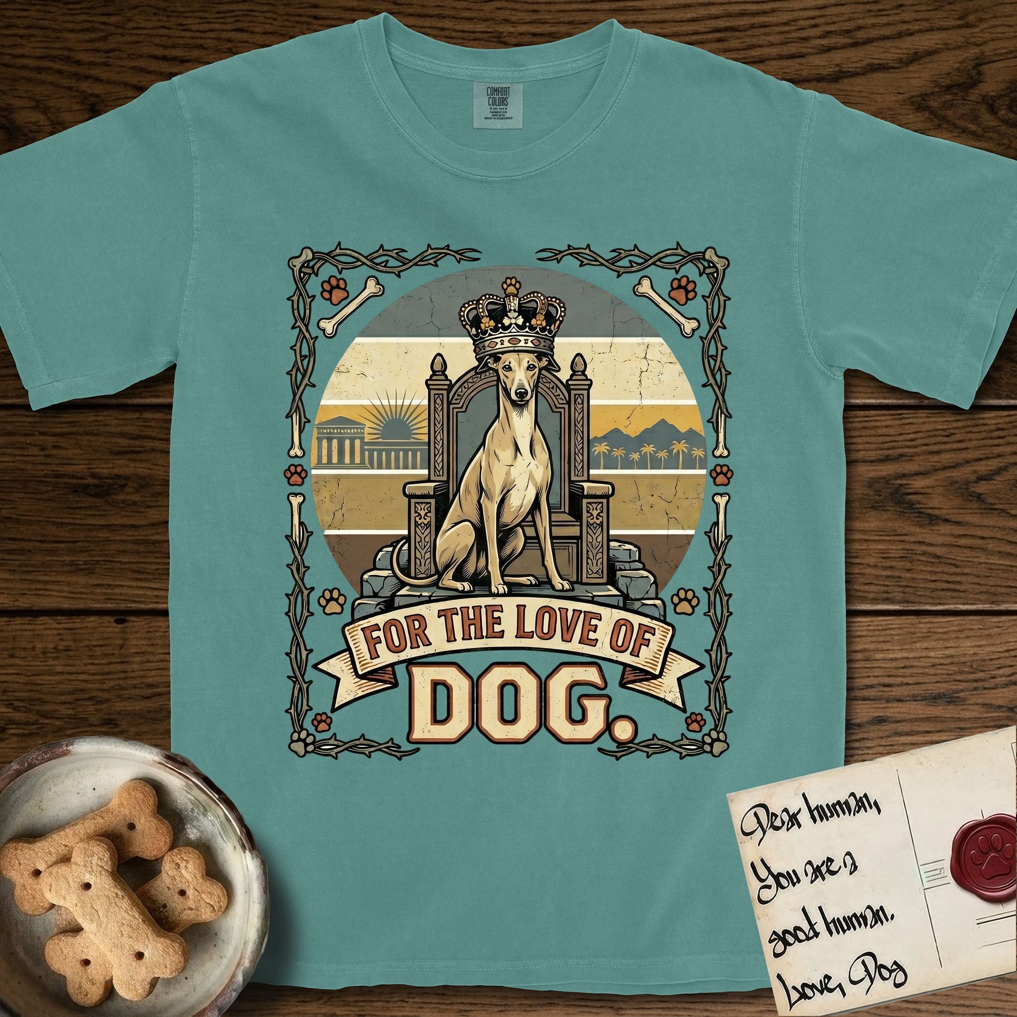 For the Love of Dog Whippet T-Shirt flat lay in Blue Spruce, featuring a vintage badge of a crowned Whippet seated on a throne.